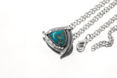 Sleeping Beauty Turquoise triangle pendant shown on white background with oxidized sterling silver sun-ray detail.