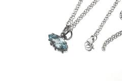 Blue Topaz oxidized silver pendant shown with chain on white background as a small eye talisman.
