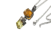 Sunstone Apatite pendant shown on a white background with oxidized sterling silver, claw-set Sunstone, and dangling Apatite crystal.