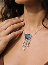 Midnight Tides Amulet shown worn on the chest, with Blue Tourmaline, Aquamarine, Blue Moonstone, and sterling silver dangles.