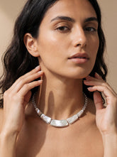Mother of Pearl sterling silver necklace shown worn on model as a luminous collarbone shell necklace.