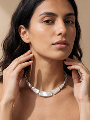 Mother of Pearl sterling silver necklace shown worn on model as a luminous collarbone shell necklace.