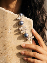 Black and white Pearl sterling silver bracelet shown on model with luminous ocean-inspired statement styling.