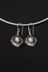 Pearl earrings shown hanging from silver choker with shell-inspired sterling silver forms.