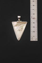 Mother of Pearl triangle pendant shown beside a ruler for pendant size reference.