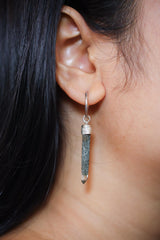Himalayan Chlorite Quartz single hoop earring shown worn on the ear, with sterling silver hoop and long raw crystal point.