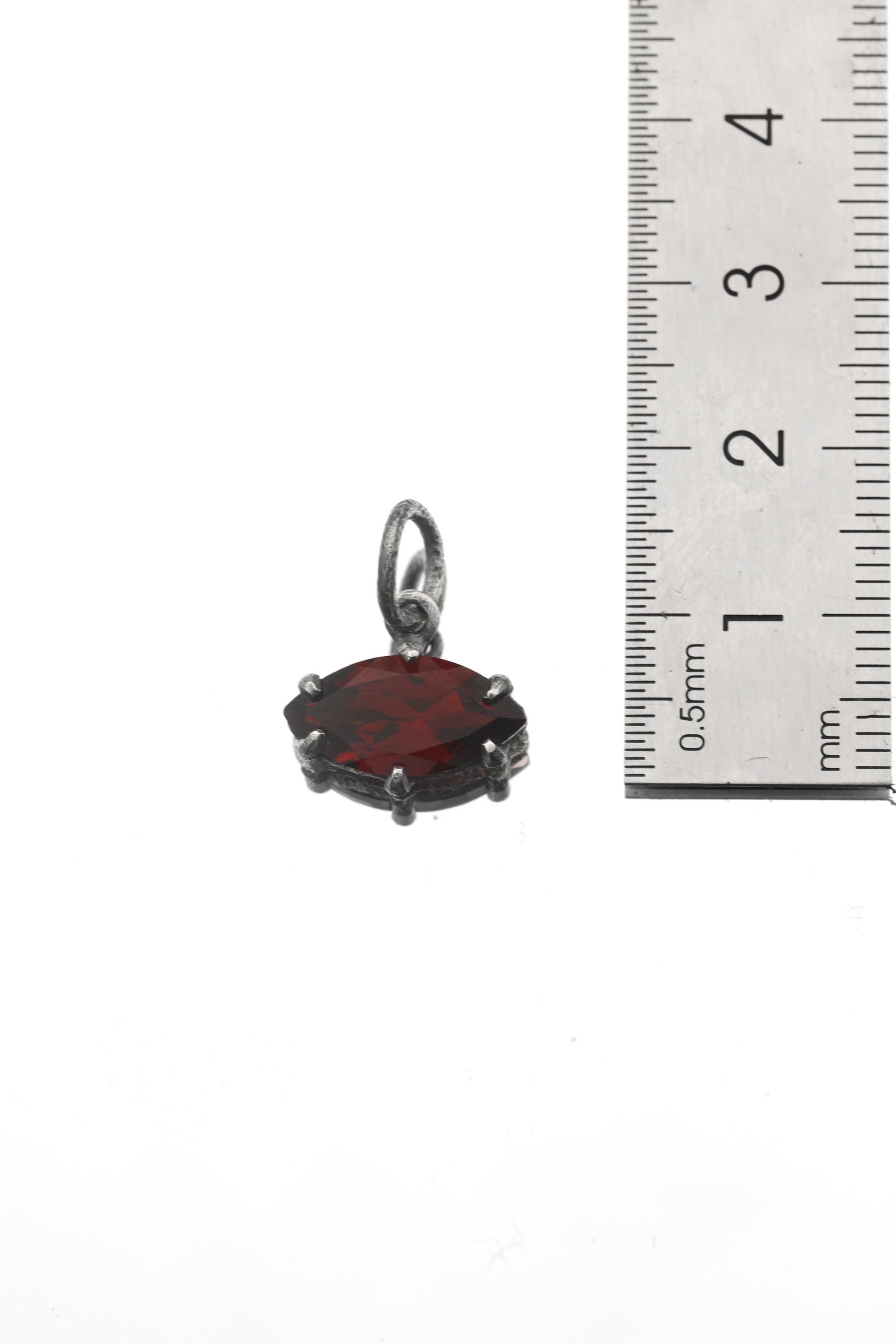 Garnet marquise pendant shown beside ruler for petite gemstone pendant size reference.