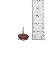 Garnet marquise pendant shown beside ruler for petite gemstone pendant size reference.