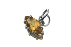 Close view of faceted Citrine pendant in oxidized sterling silver claw setting.
