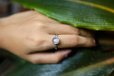 Purple Labradorite Silver Ring shown worn on hand with round gemstone and fine hand-hammered sterling silver band.