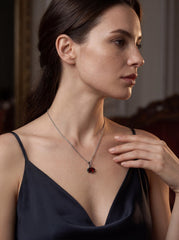 Garnet marquise sterling silver pendant worn as a small deep red gemstone necklace.