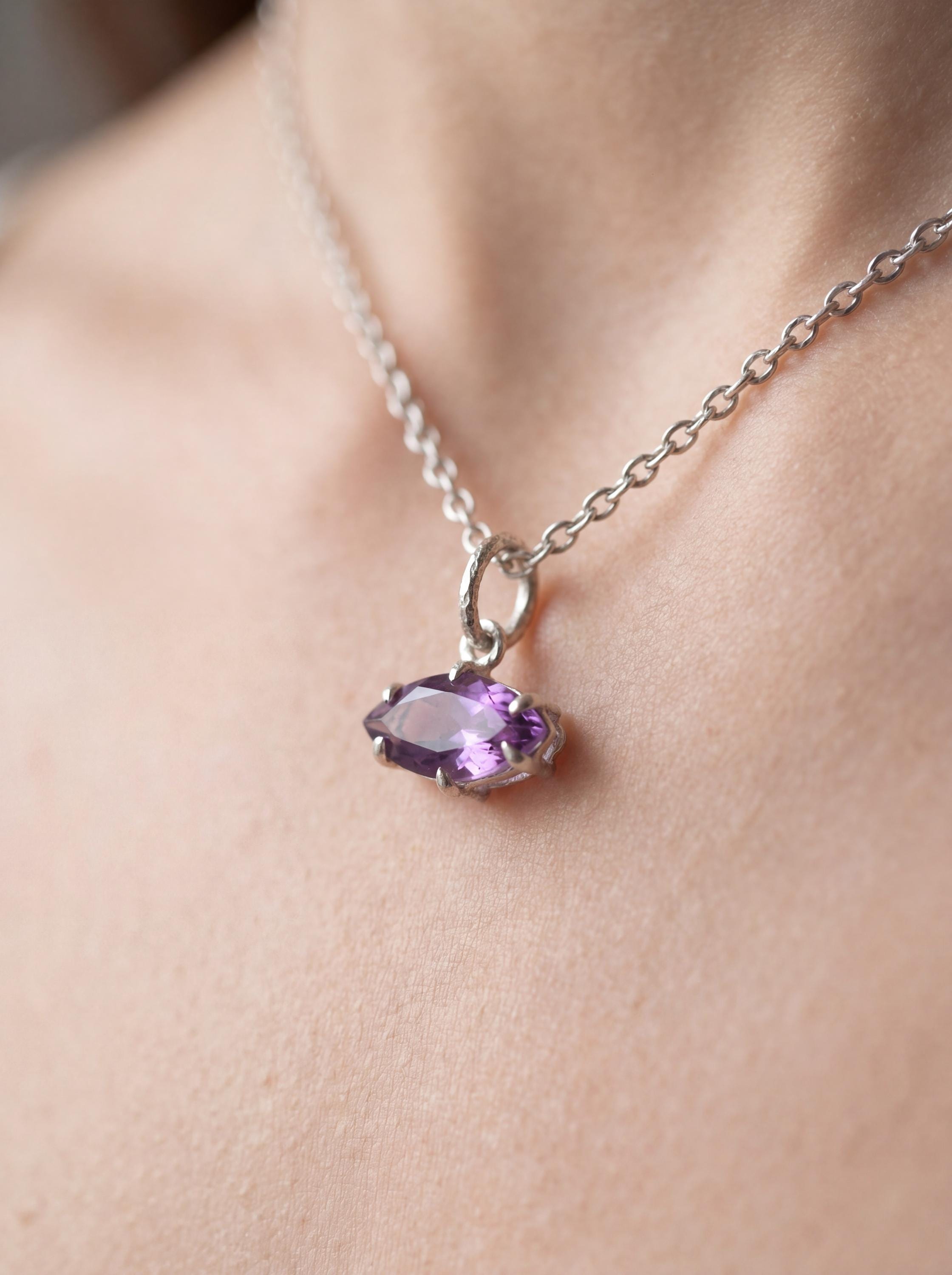 Amethyst marquise sterling silver pendant shown worn as a small violet gemstone necklace.
