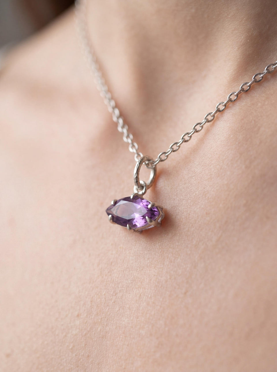 Amethyst marquise sterling silver pendant shown worn as a small violet gemstone necklace.