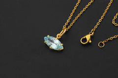 Blue Topaz marquise pendant shown with gold-plated chain as a petite blue gemstone charm.