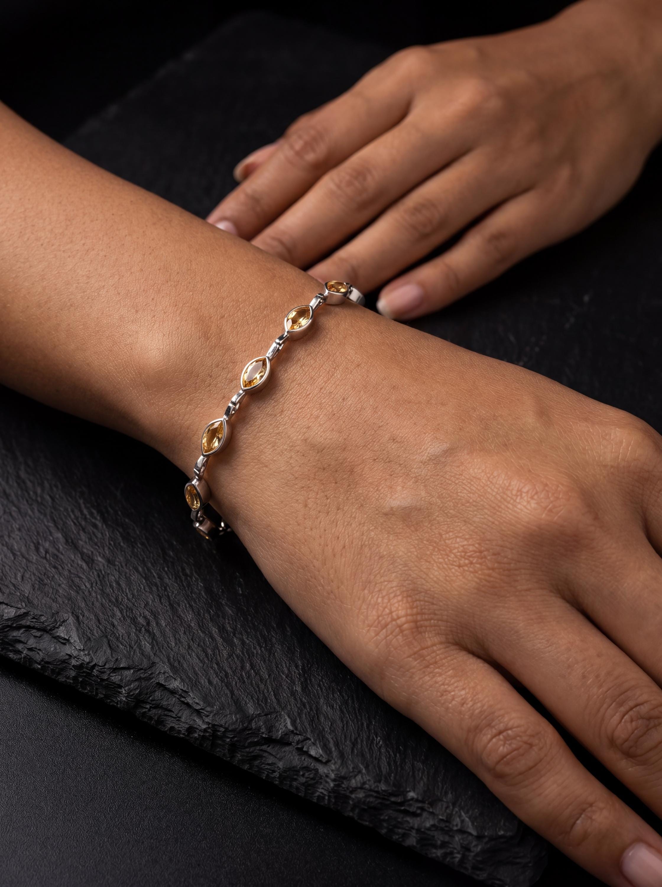 Citrine sterling silver bracelet shown worn on the wrist with golden marquise gemstones and polished silver links.