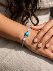Turquoise Moonstone bracelet shown on model with polished silver snake chain and three-stone centrepiece.