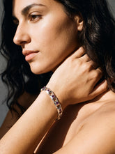 Amethyst sterling silver bracelet shown worn on model with square purple gemstones and polished silver links.