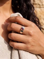 Crimson Garnet ring shown worn on hand with polished sterling silver and red gemstone centre.