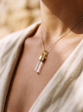 Hand-fossicked Australian Quartz point pendant shown worn on a necklace, with 18k gold-plated sterling silver cap and coastal crystal charm.