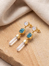 Blue Moonstone, Blue Apatite, and Clear Quartz gold-plated sterling silver stud drop earrings shown on soft fabric.