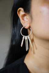 Clear Quartz Pearl hoop earring worn on a model, showing large silver circle and stacked gemstone movement.