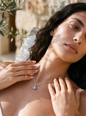 Blue Topaz marquise sterling silver pendant shown worn as a small sky-blue gemstone necklace.