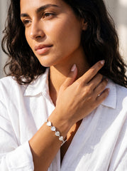 Mother of Pearl heart bracelet shown worn on model as a soft handmade sterling silver shell bracelet.