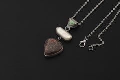 Shadow Tide Pearl pendant shown on dark background with South Sea Pearl and Black Rutile Quartz.