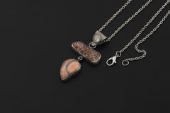 Ruby Rhodochrosite Moonstone pendant shown worn on model with oxidized sterling silver chain.