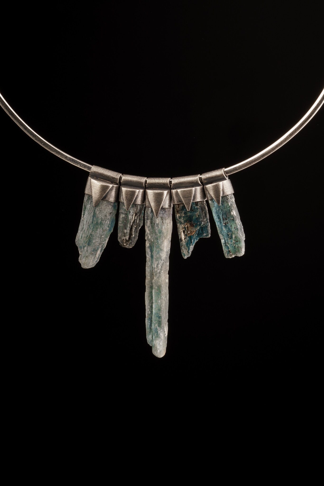 Nepal Chlorite Rutile Phantom Quartz Stack Pendants shown together on black background with oxidized silver caps.