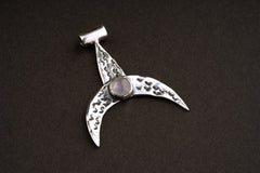Moon Whale Blue Moonstone pendant shown on dark background with oxidized sterling silver crescent shape.