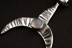 Close-up of Crescent Whale Moonstone pendant showing textured oxidized silver and lunar gemstone detail.