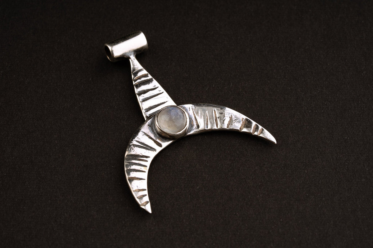 Crescent Whale Moonstone pendant shown on dark background with oxidized sterling silver and Blue Moonstone accent.