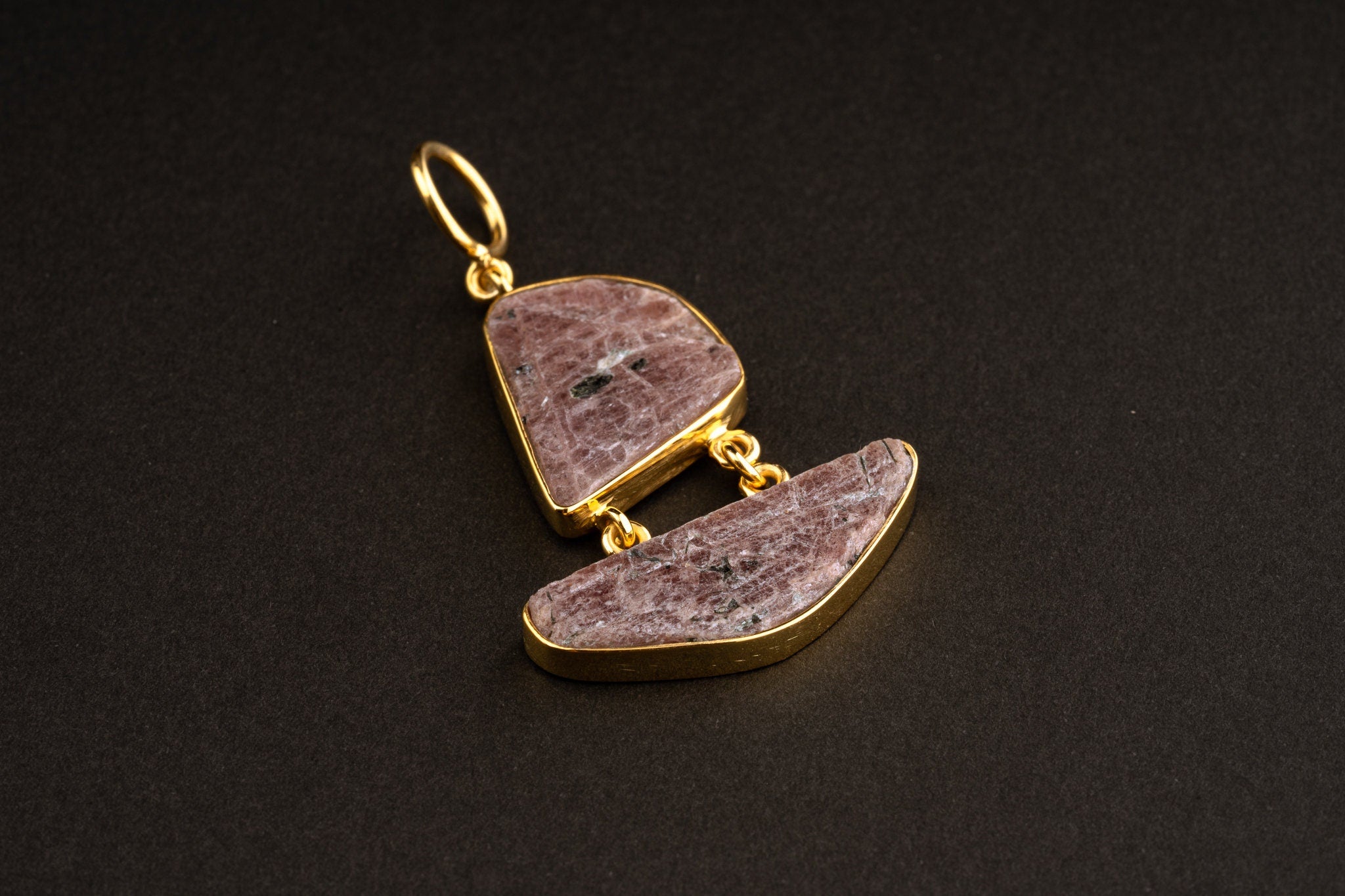 Double raw Ruby pendant shown worn on a necklace, with two linked stones, gold-plated caps, and compact drop shape.