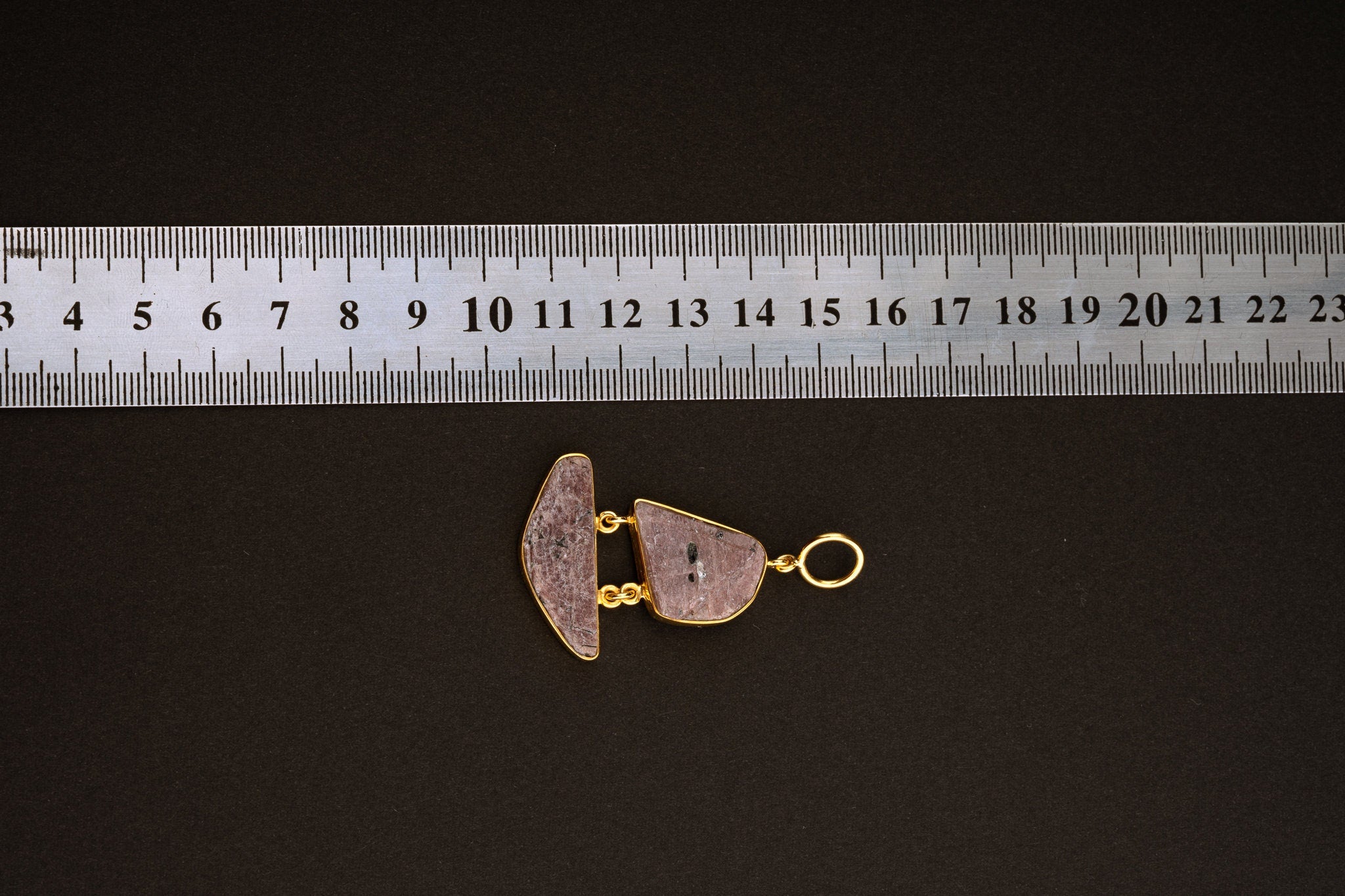 Double raw Indian Ruby pendant shown beside a ruler for scale, measuring approximately 4 cm total length including bail.