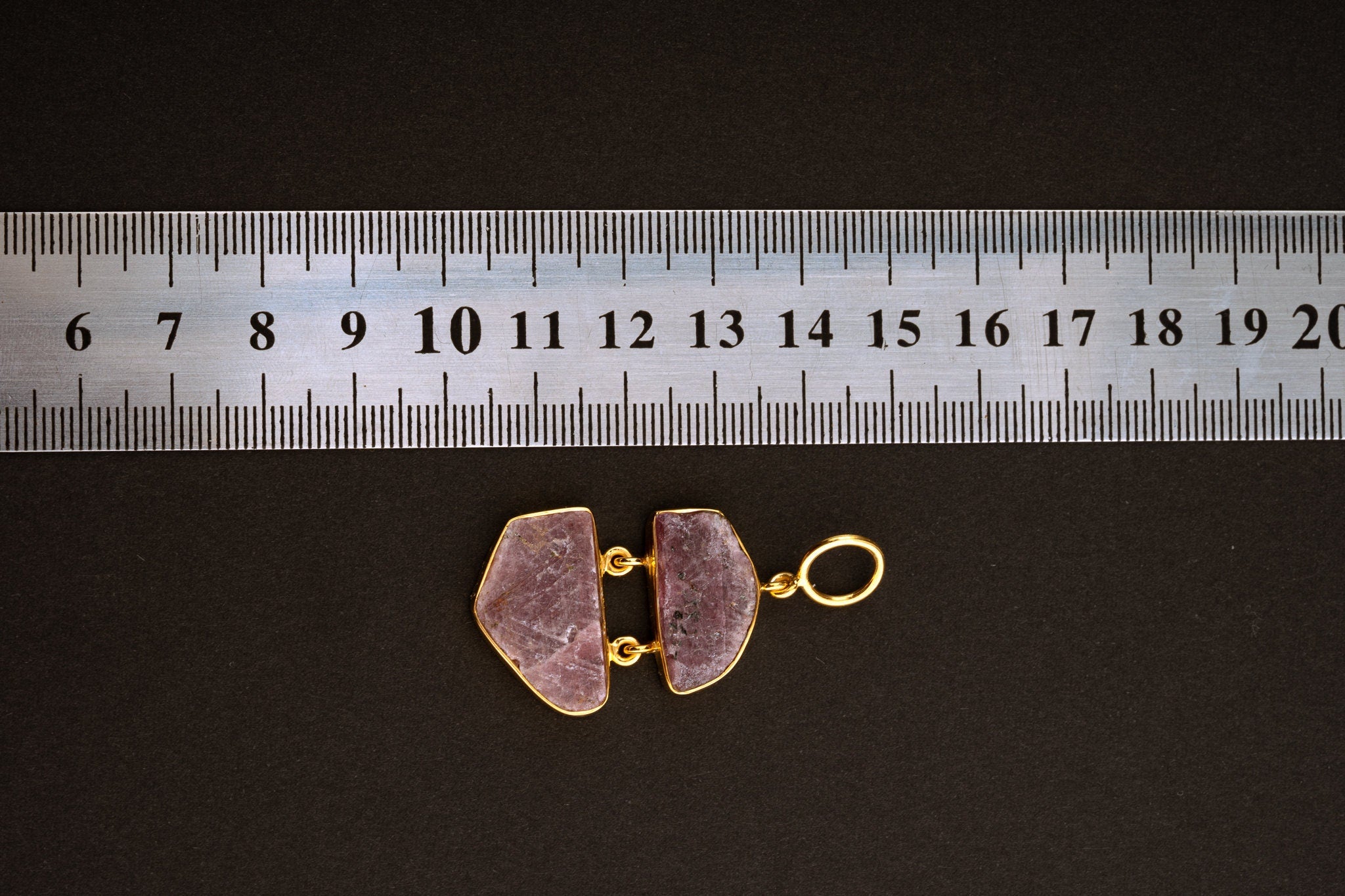 Double raw Indian Ruby pendant shown beside a ruler for scale, measuring approximately 4 cm total length including bail.