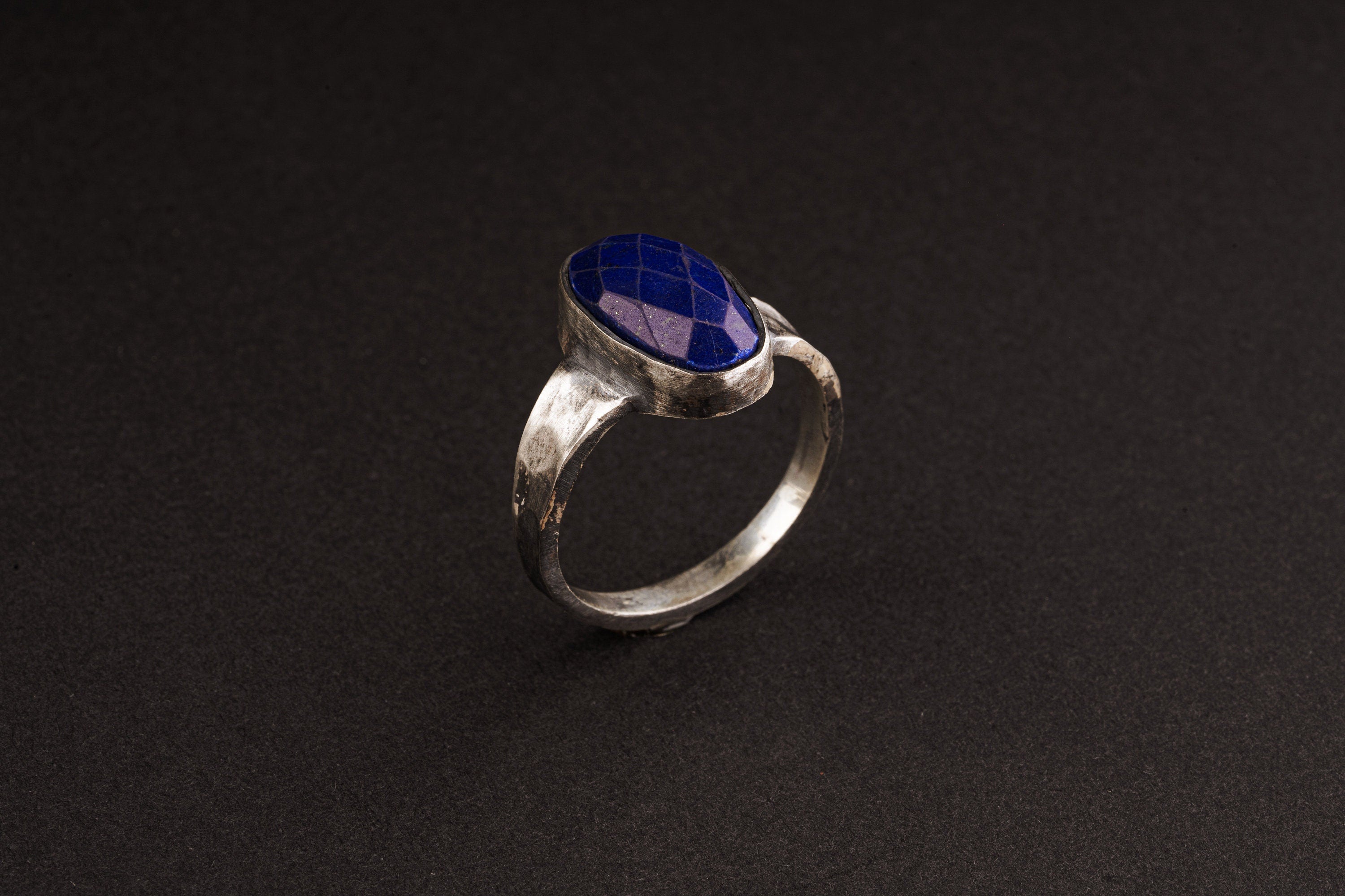 Side view of Lapis Lazuli ring showing oxidized sterling silver texture, raised bezel setting, and strong ring profile.