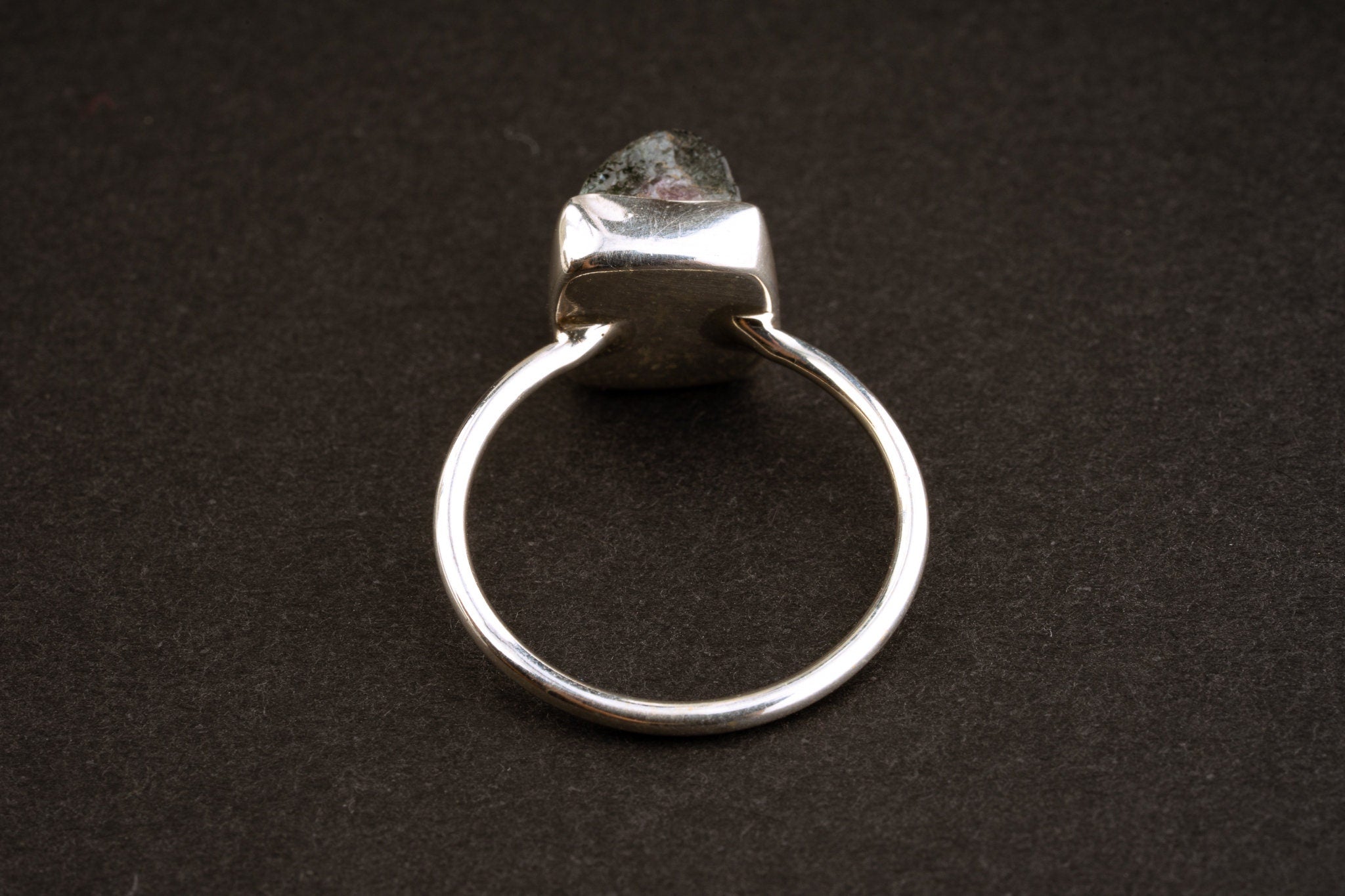 Back view of Watermelon Tourmaline sterling silver stack ring showing the fine round band and raised raw crystal setting.