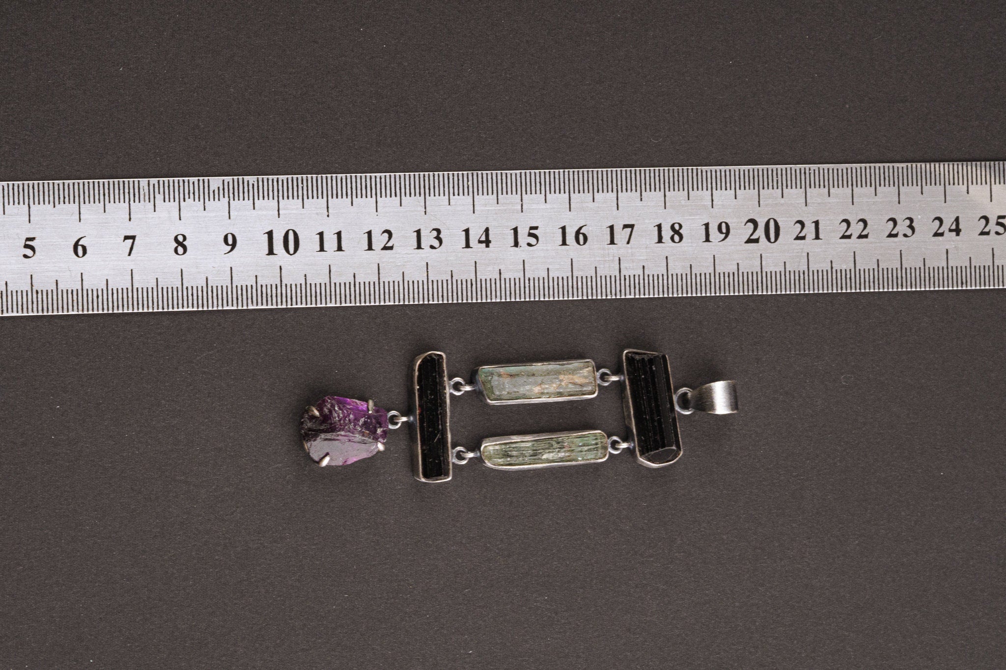 Aquamarine Tourmaline Amethyst pendant shown beside a ruler for scale, with large hinged five-stone construction.