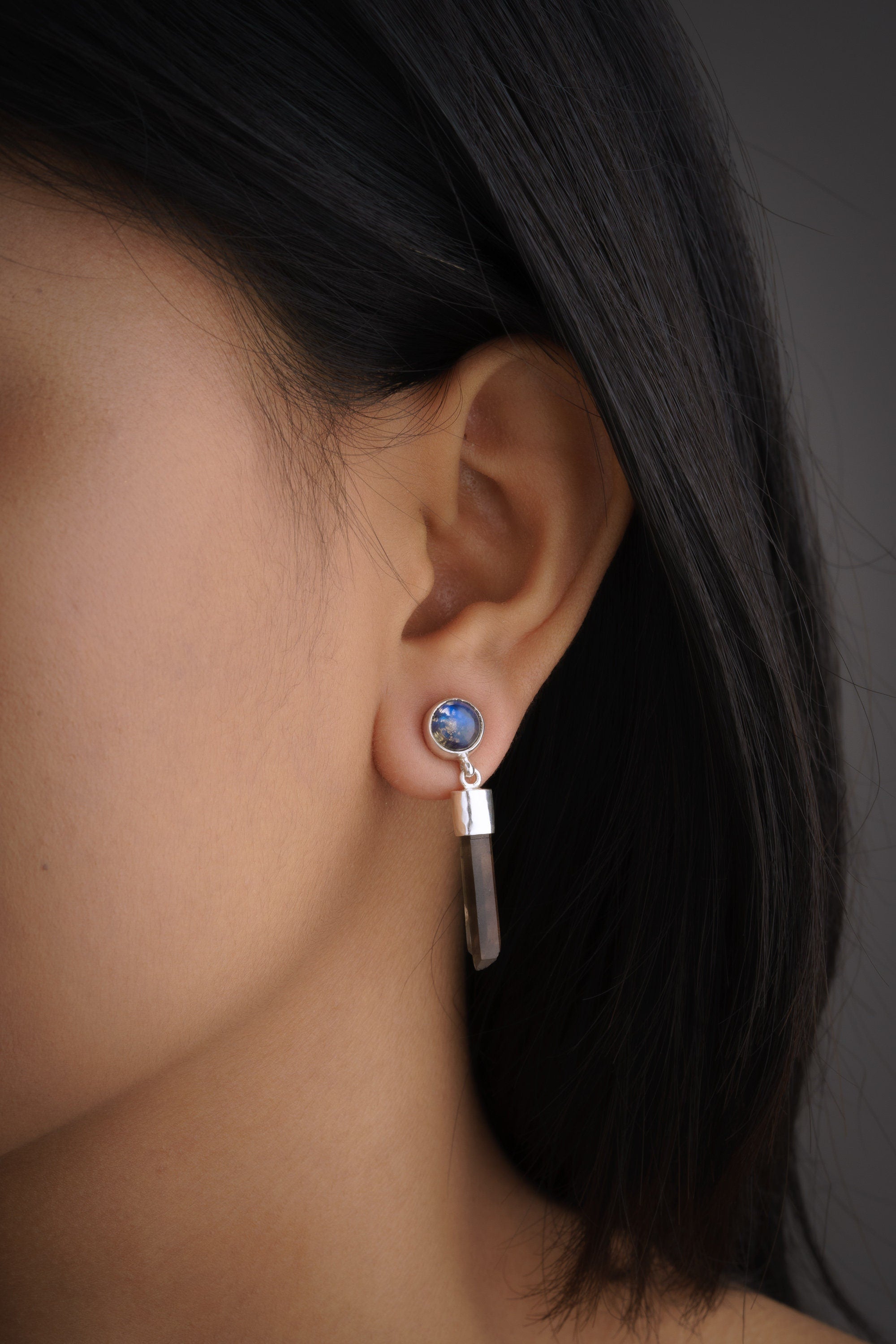 Smoky Quartz Labradorite drop earrings shown worn on the ear, with sterling silver stud tops and long crystal dangles.