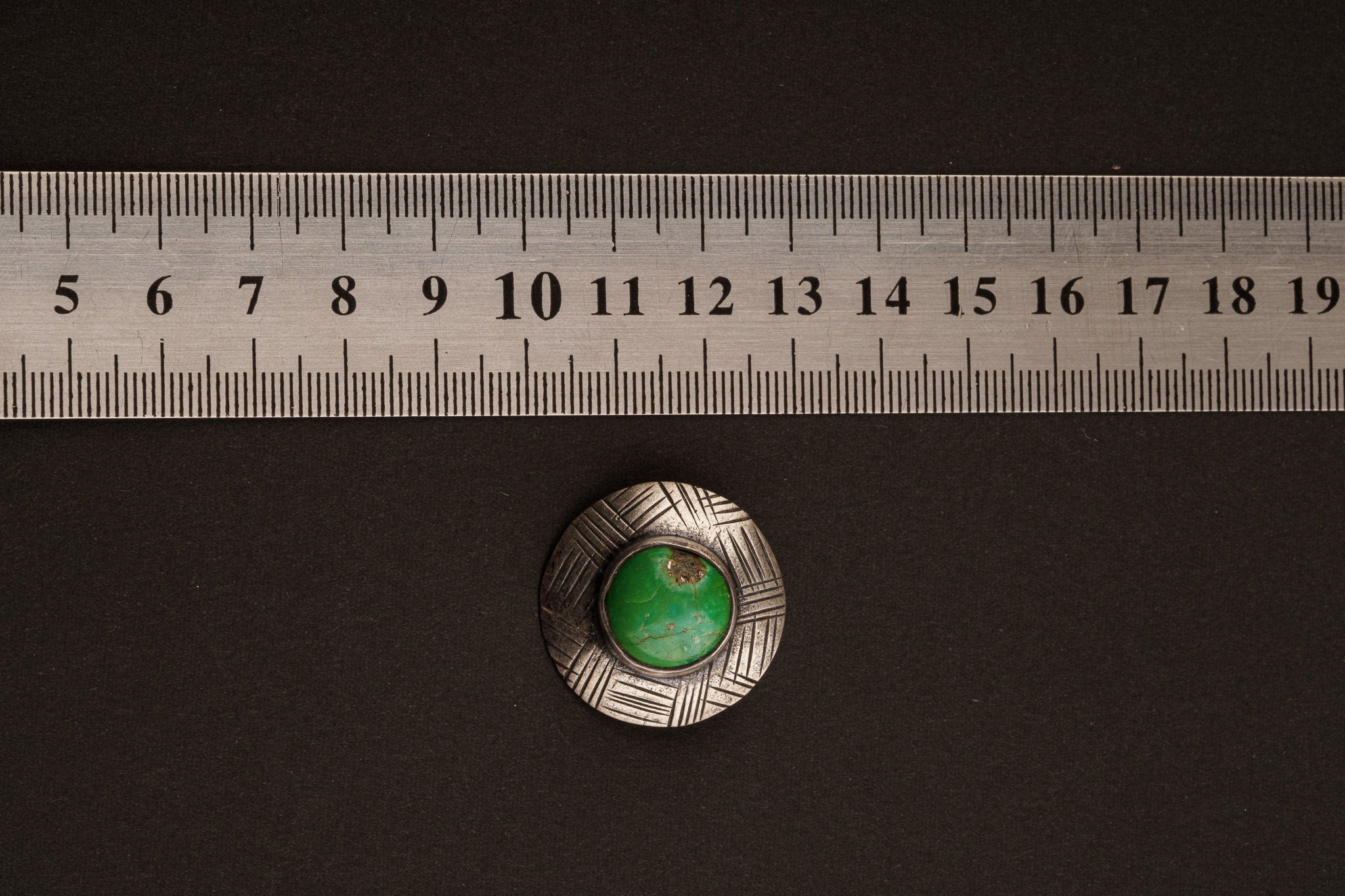 Green Turquoise Shield Stack Pendant shown beside ruler for approximate size reference.