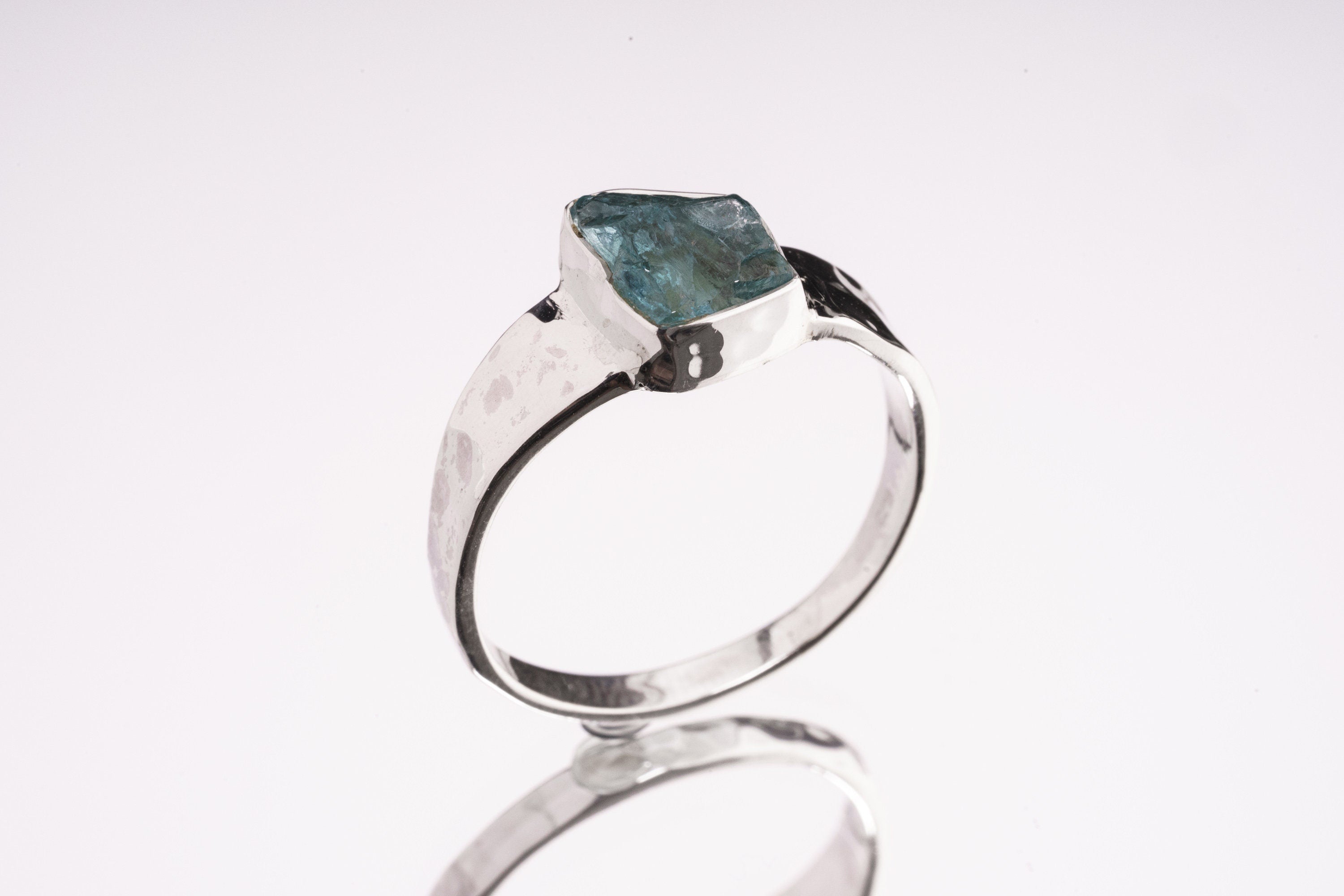 Blue Apatite Textured Silver Ring shown from the side with hand-textured sterling silver band and raised blue stone.