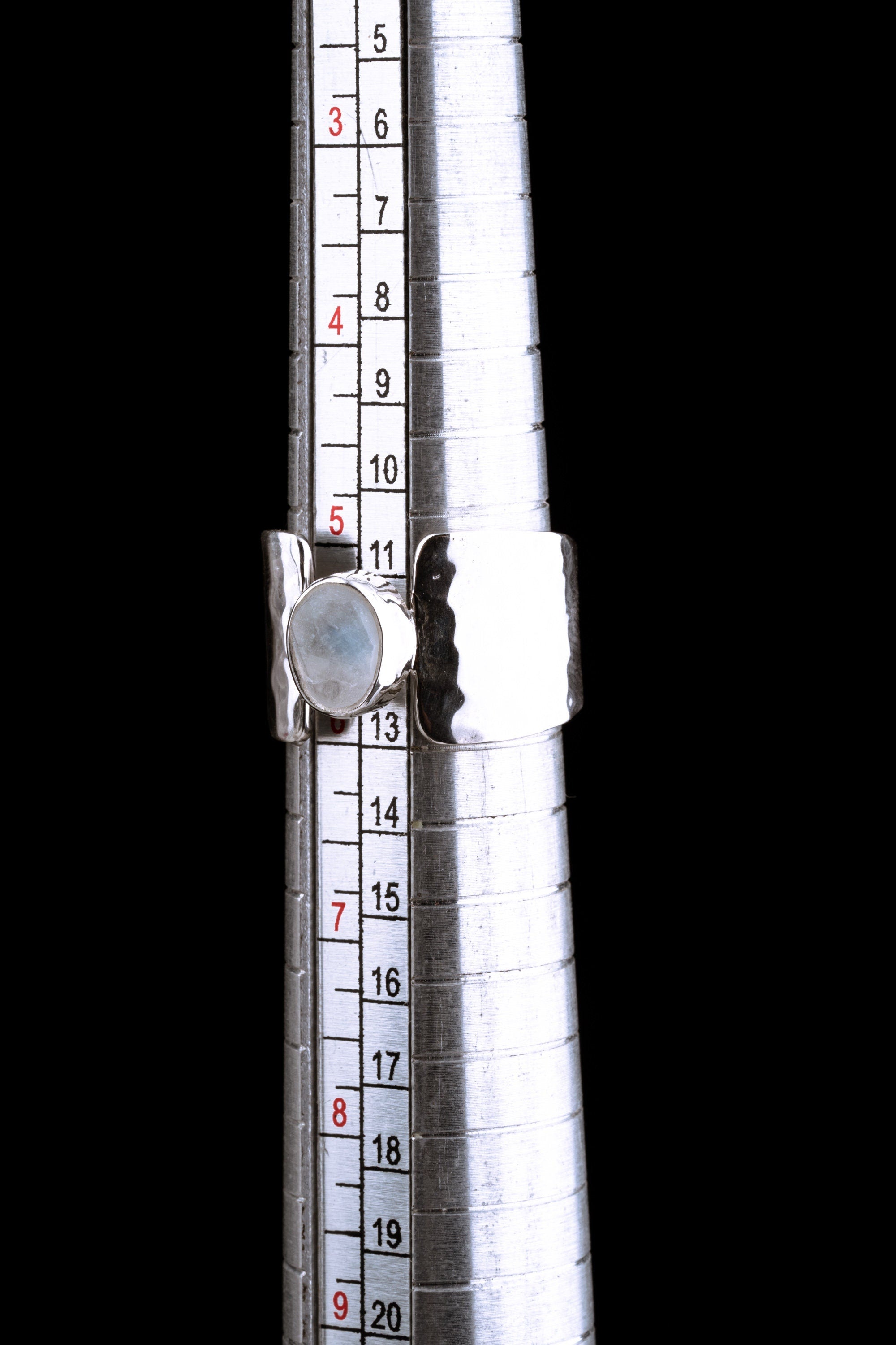 Blue Moonstone Hammered Silver Ring shown beside a ruler for size reference with wide hammered sterling silver band.