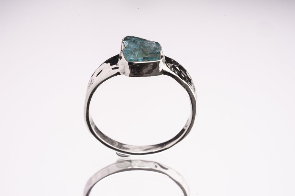 Blue Apatite Textured Silver Ring shown on white background with natural blue gemstone and sterling silver bezel setting.