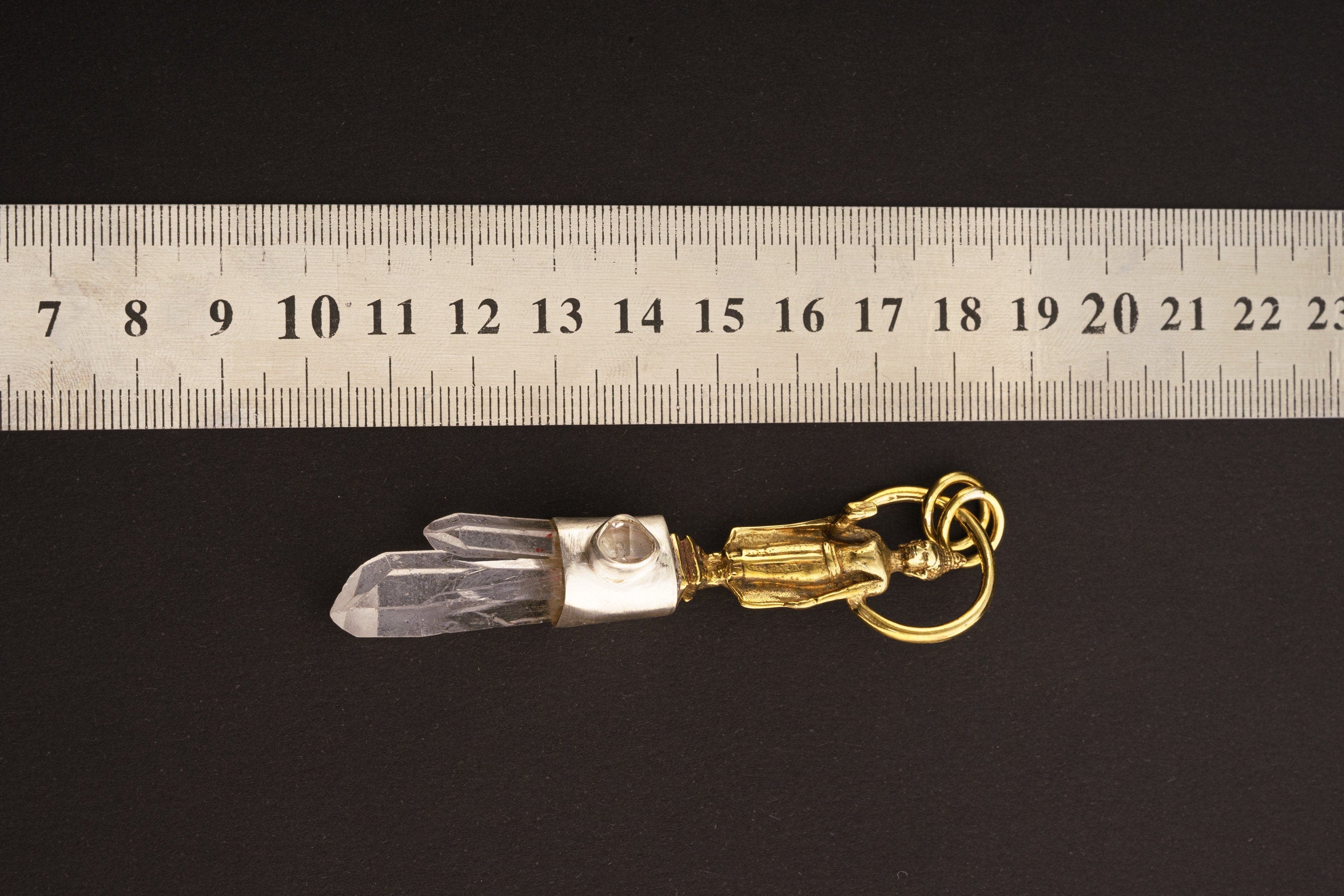 Buddha Twin Quartz Herkimer Diamond pendant shown beside a ruler for scale with clear crystal and brass Buddha crown.
