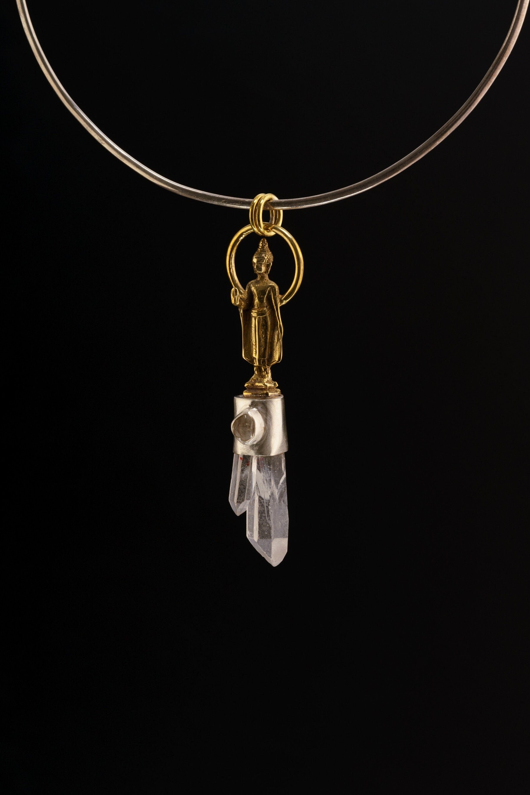 Buddha Twin Quartz Herkimer Diamond pendant shown on black background with softly oxidized silver and brass detail.