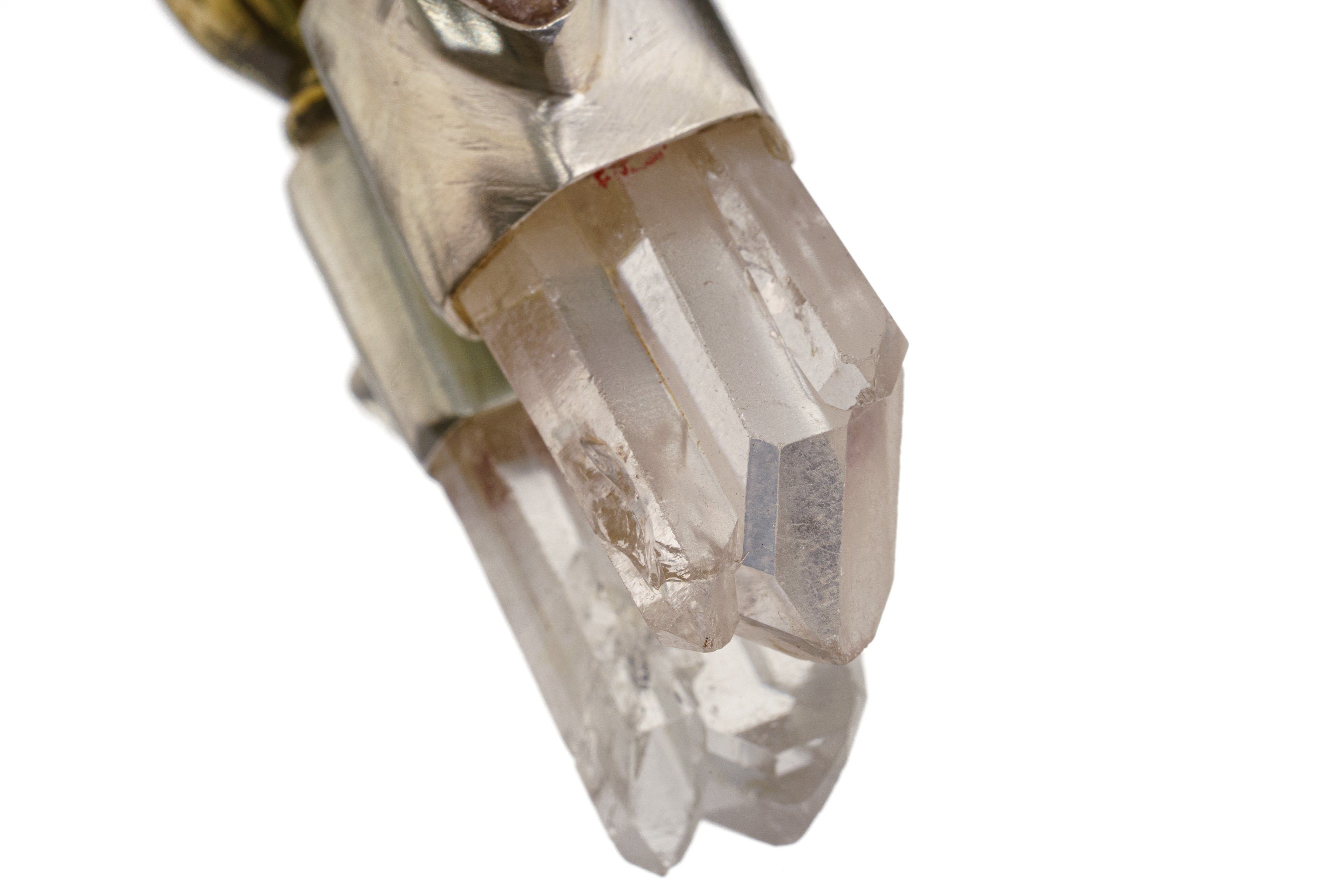 Close-up of Clear Quartz point and Amethyst in a Sun Wukong Buddha Hand sterling silver and brass talisman.
