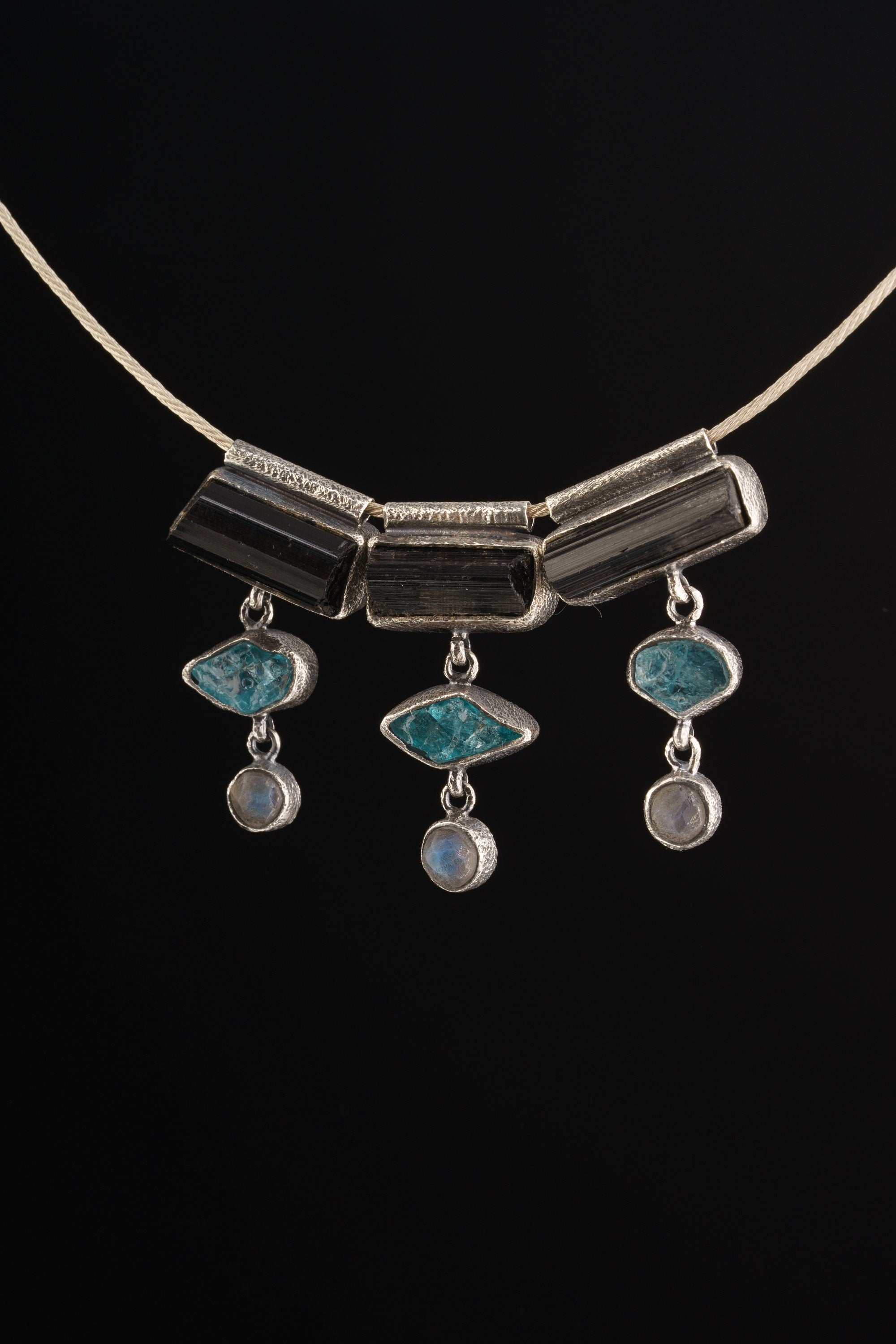 Grounding Vision Stack Pendant with Black Tourmaline, Blue Apatite, and Labradorite in oxidized sterling silver, shown on black cord.