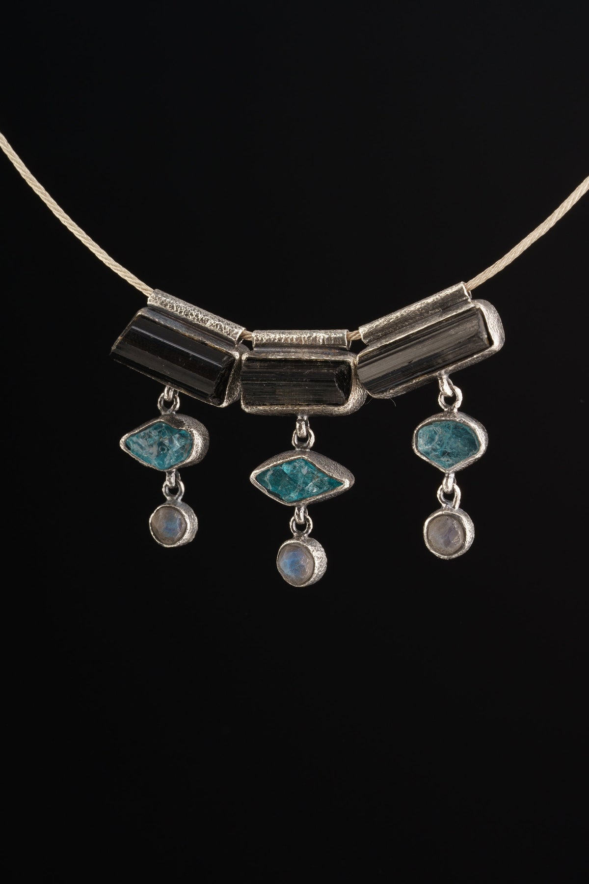 Grounding Vision Stack Pendant with Black Tourmaline, Blue Apatite, and Labradorite in oxidized sterling silver, shown on black cord.
