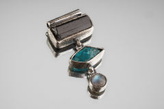 Stack Pendant on black background with Black Tourmaline, Blue Apatite, Labradorite, and sand-textured sterling silver.